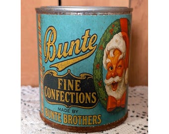 Lata de pinta navideña de Bunte Bros. FINE CONFECTIONS con diseño vintage oxidado.