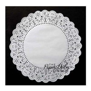 May include: White paper doily with a delicate lace pattern. The doily is round and has a diameter of approximately 10 inches.