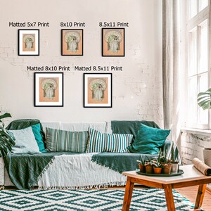 May include: A living room interior with a couch, a coffee table, and a white brick wall. There are four framed prints of a woman in a dress on the wall, with the dimensions of each print listed below the frame. The prints are in various sizes, including 5x7, 8x10, and 8.5x11 inches.