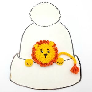 May include: A white crocheted hat with a pom-pom on top. A yellow crocheted lion with an orange mane is peeking out of the hat.