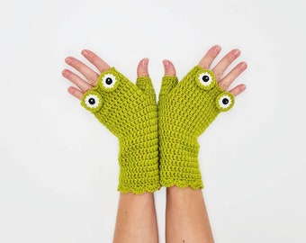 May include: A pair of green fingerless gloves with white eyes and a scalloped edge.