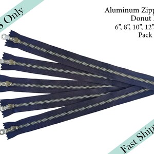 May include: A pack of five navy blue zipper closures with silver donut pull tabs. The zippers are available in sizes 6, 8, 10, 12, and 14 inches.  Aluminum Zippers Donut Pull. Pack of 5.
