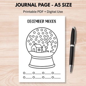 May include: A black and white journal page with the text "JOURNAL PAGE - A5 SIZE" and "Printable PDF + Digital Use". The page features a snow globe illustration with the words "DECEMBER MOODS". A black pen is on the right.