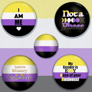 May include: Four round buttons with the non-binary pride flag colors. The buttons have different messages: "I AM ME", "Not a Phase", "Leave Binary to the Computers", and "My Gender is ENBY None of your Business!"