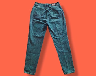 May include: Dark teal high-waisted jeans with a straight leg. The jeans have a classic five-pocket design and a "WAVE" label on the back waistband. The denim has a slightly faded appearance, suggesting a vintage style.