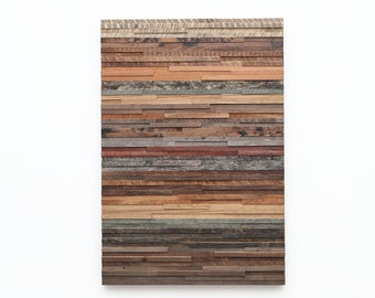 May include: A wall art piece made of reclaimed wood planks in various shades of brown, gray, and red. The planks are arranged horizontally in a staggered pattern, creating a textured and rustic look.