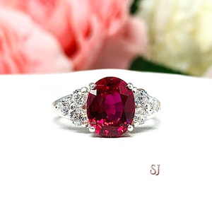 Lab Created Ruby Oval Ring Round CZ Accented Sterling Silver