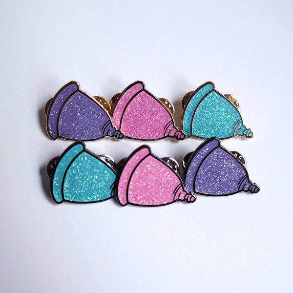 1.25" Glitter Menstrual Cup Lapel Pin in pink, blue, and purple, in gold and black nickel