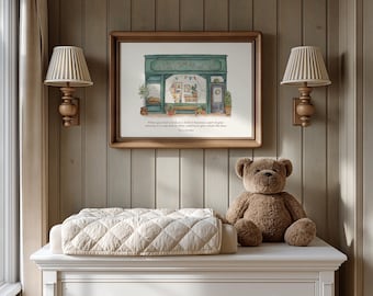 May include: A framed horizontal print featuring a watercolor illustration of a green storefront with a window display, accompanied by the text: When you read a book as a child, it becomes a part of your identity in a way that no other reading in your whole life does.