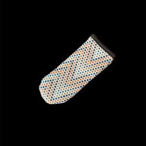 May include: A blue and white pot holder with a pattern of orange and black dots. The pot holder has a brown trim around the edges.