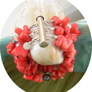 May include: A coral and pearl bracelet with a silver toggle clasp. The bracelet is made of natural coral and freshwater pearls.
