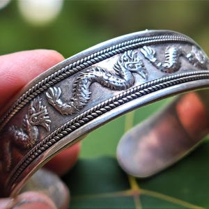 May include: A rustic wooden sign with the text "Welcome to our home" in white lettering. The sign features a distressed finish and a simple, inviting design, perfect for a front porch or entryway.