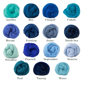 May include: A collection of colorful wool roving in various shades of blue and green. Each color is labeled with a name, including "Antilles," "Bay," "Chagall," "Cobalt," "Dream," "Evening," "Jeans," "North Sea," "Paradise," "Peacock," "September," "Sunrise," "Teal," "Tuareg," and "Water."
