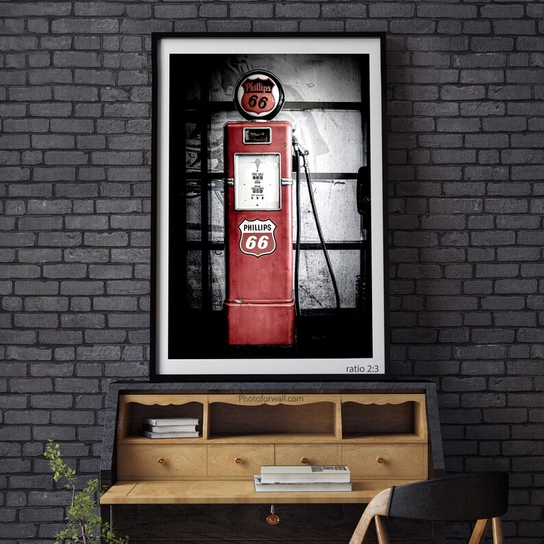 a red gas pump sitting on top of a wooden desk