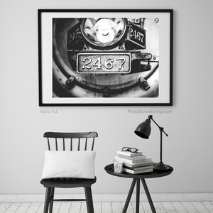 a black and white photo of a chair and a table