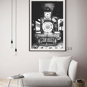 a black and white photo of a train in a living room