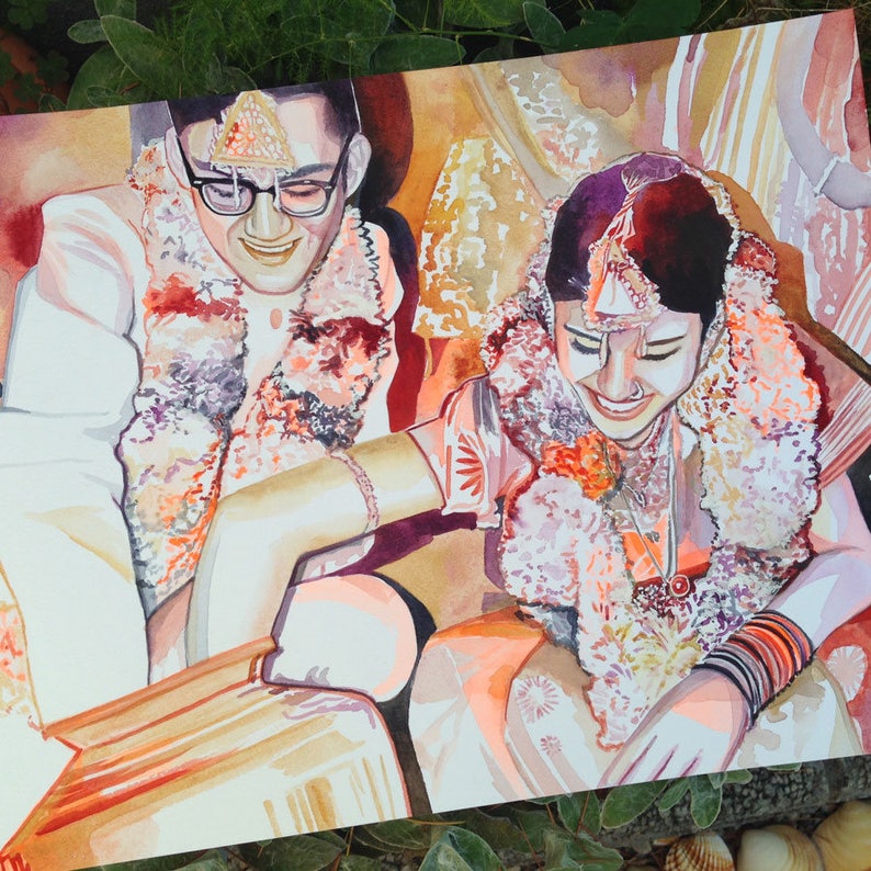 May include: A watercolor painting of a couple in traditional Indian wedding attire. The bride is wearing a pink and gold dress with floral embellishments and a red bindi on her forehead. The groom is wearing a white and gold sherwani with a floral garland around his neck. The painting is set against a light brown background.