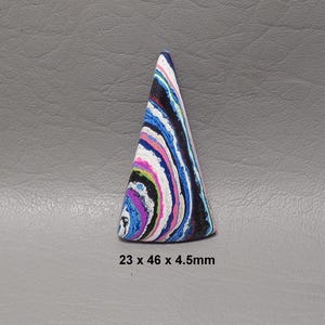 May include: A colorful, cone-shaped object with a swirling pattern of blue, white, pink, and black. The base measures 23mm x 46mm, and it is 4.5mm thick. The object is set against a gray background.