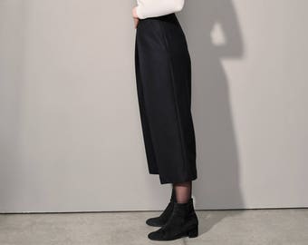 High-waisted wide wool trousers with deep pleats and side pockets, wool culottes with viscose lining