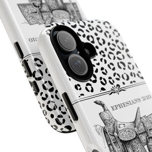 May include: A white phone case featuring a black leopard print pattern on the top half and a detailed black and white illustration of a western saddle on the bottom half, with the text EPHESIANS 2:10 printed above the saddle illustration.