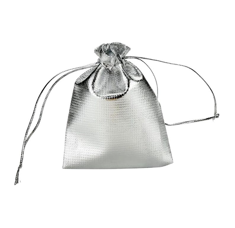 May include: A silver drawstring bag made of a shimmery, textured fabric. The bag is empty and has a white background.
