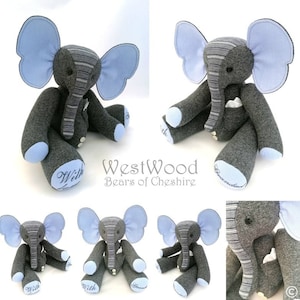 May include: A grey and blue elephant soft toy with striped fabric and embroidered text on the feet. The text reads "With" and "Grandad".