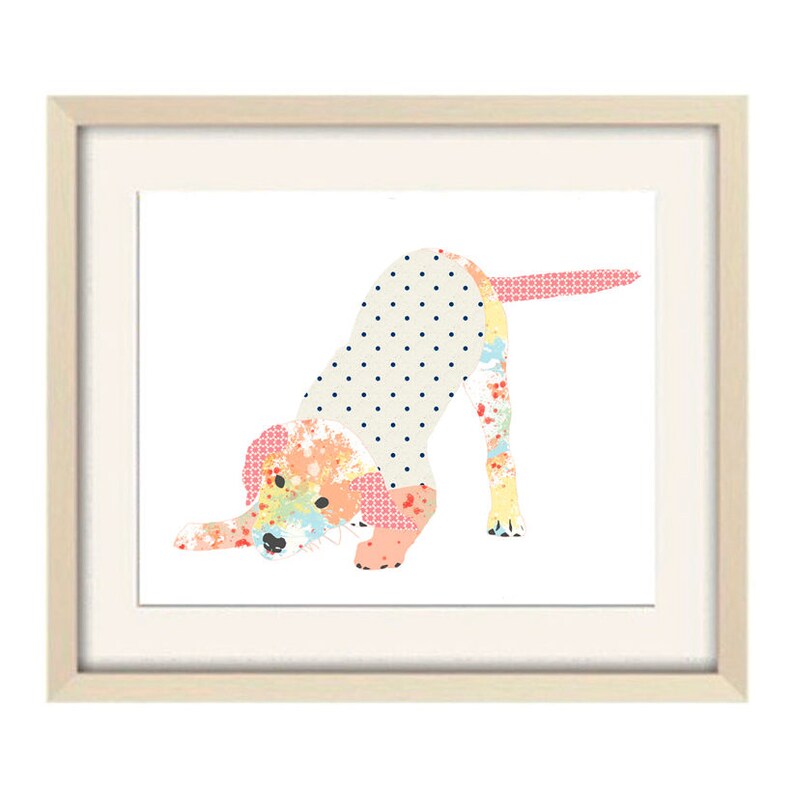 May include: A framed print of a colorful patchwork dog illustration. The dog is in a playful pose, with its head down and its tail wagging. The print is set against a white background.