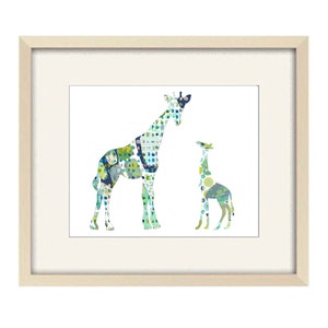 May include: A framed print of two giraffes, a larger one and a smaller one, made of colorful patterned fabric. The giraffes are outlined in white against a white background.