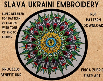 May include: A colorful embroidered mandala pattern with a black and white striped center, surrounded by green leaves and red flowers. The text "SLAVA UKRAINI EMBROIDERY" is at the top of the image, and the text "PROCEEDS BENEFIT UKR" is at the bottom left. The text "PDF PATTERN DOWNLOAD" is at the top right. The text "ERICA ZUBRIS FIBER ART" is at the bottom right.