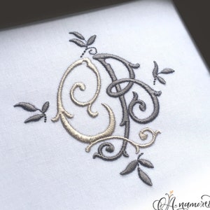 May include: Embroidered monogram with the letters "OP" in gold and gray thread, adorned with leaf accents, on a white fabric. The image includes the Anamored logo.