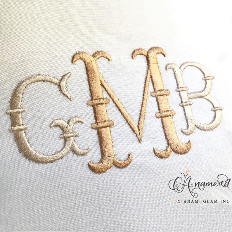 May include: Embroidered monogram with the letters G, M, and B in a script font. The letters are in a gold color with a white outline.