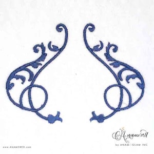 May include: Two blue embroidered decorative swirls, each with a loop at the bottom, on a white background.