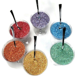 May include: Six small glass bowls filled with different colored glitter, each with a silver spoon inside. The colors are purple, red, blue, orange, gold, and green.