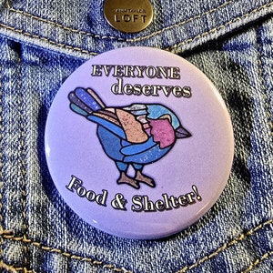May include: Purple button with a stylized bird illustration and the text "Everyone deserves Food & Shelter!"