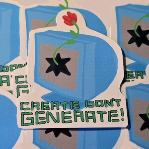 May include: A die-cut sticker featuring a light blue computer monitor with a gray screen displaying a black star icon. A green vine with a small red flower grows from the star. Below the monitor, the text reads CREATE DON'T GENERATE!