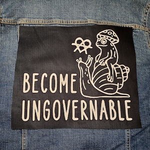 May include: A black patch with white text and a graphic of a frog riding a snail. The text reads "Become Ungovernable".