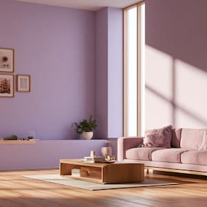 May include: A living room featuring a light purple wall with four framed pictures, a wooden coffee table, and a pink sofa. A potted plant sits on the floor next to the sofa, while a built-in shelf holds books and small decorative items on the left.