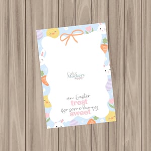 May include: An Easter-themed card with a light blue background and a white, scalloped border. The card features illustrations of bunnies, chicks, carrots, and flowers. The text on the card reads "an Easter treat for some bunny sweet."