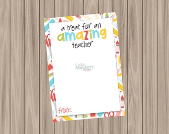 May include: A white card with the text "a treat for an amazing teacher" in colorful letters. The card has a border with school supplies like scissors, pencils, and crayons. The words "from:" are at the bottom.
