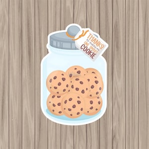May include: A glass jar filled with chocolate chip cookies with a tag attached that reads "Thanks for making me one smart cookie".