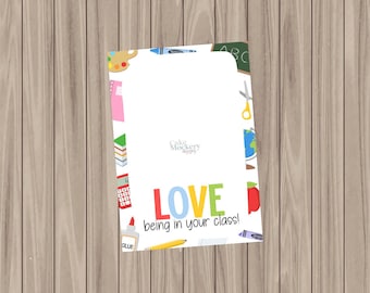 May include: A white card with a colorful border of school supplies. The card says "LOVE being in your class!" with the word "LOVE" in rainbow colors.