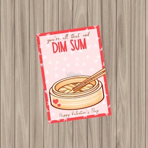 May include: A pink and red Valentine's Day card with the text "You're all that and Dim Sum" and a cartoon illustration of a bamboo steamer with chopsticks. The card has a pink background with white hearts.