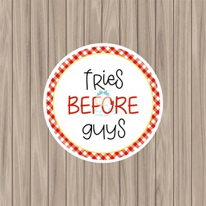 May include: A white circle with red and yellow checkered border. The text "fries before guys" is written in black.