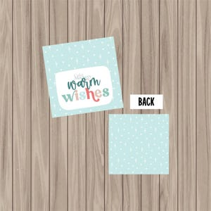 May include: Two square gift tags with a light blue background and white starburst pattern. One tag has the words "warm wishes" in a whimsical font. The other tag has the word "BACK" in black text.