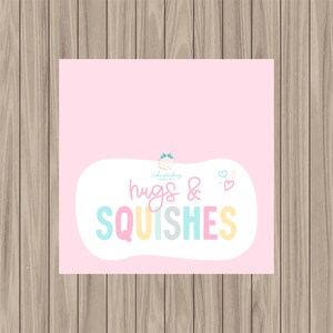 May include: A pink background with a white speech bubble containing the text "Cake Making hugs & SQUISHES" in rainbow colors. The text is in a playful, handwritten font.