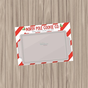 May include: A red and white striped background with the text "North Pole Cookie Co. Baking Santa's Favourites Since 1850" and a white baking sheet.