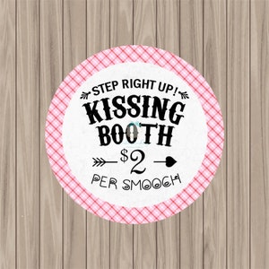 May include: A pink and white checkered circle sign with the text "STEP RIGHT UP! KISSING BOOTH $2 PER SMOOCH" in black.