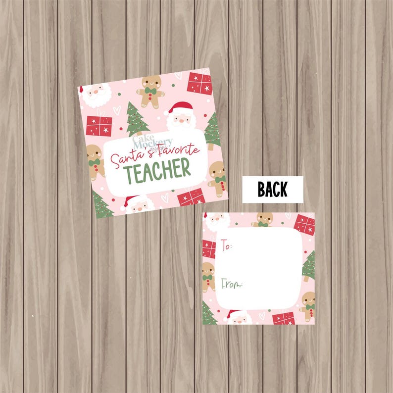 May include: Two pink Christmas gift tags on a wooden surface. One tag says "Santa's Favourite Teacher" with gingerbread men, Santa, and Christmas trees. The second tag has space for "To" and "From".