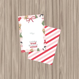 May include: A festive greeting card and envelope set. The card has a pink border decorated with gingerbread men, penguins, and Christmas trees. The text reads "a holiday treat for someone sweet." The envelope is striped in red and pink.