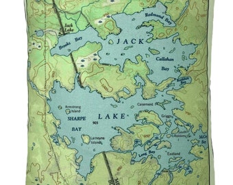 May include: Rectangular pillow featuring a vintage map of Jack Lake, Sharpe Lake, and surrounding areas. The map is in shades of blue, green, and brown, with place names and contour lines. The pillow has a light green border.